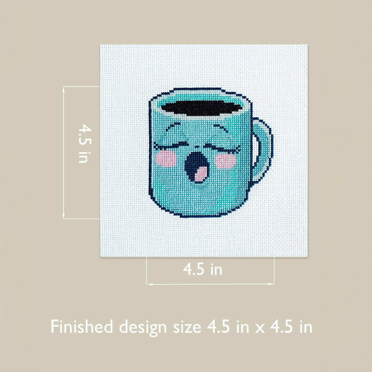 Cross-stitched design of a blue mug with measurements on a beige background
