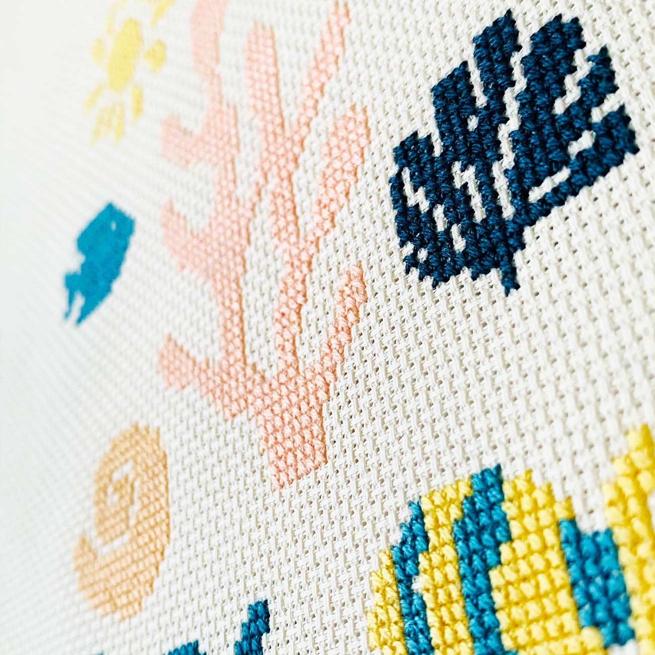 Close-up of Ocean Daydream cross stitch showing thread texture and color details.