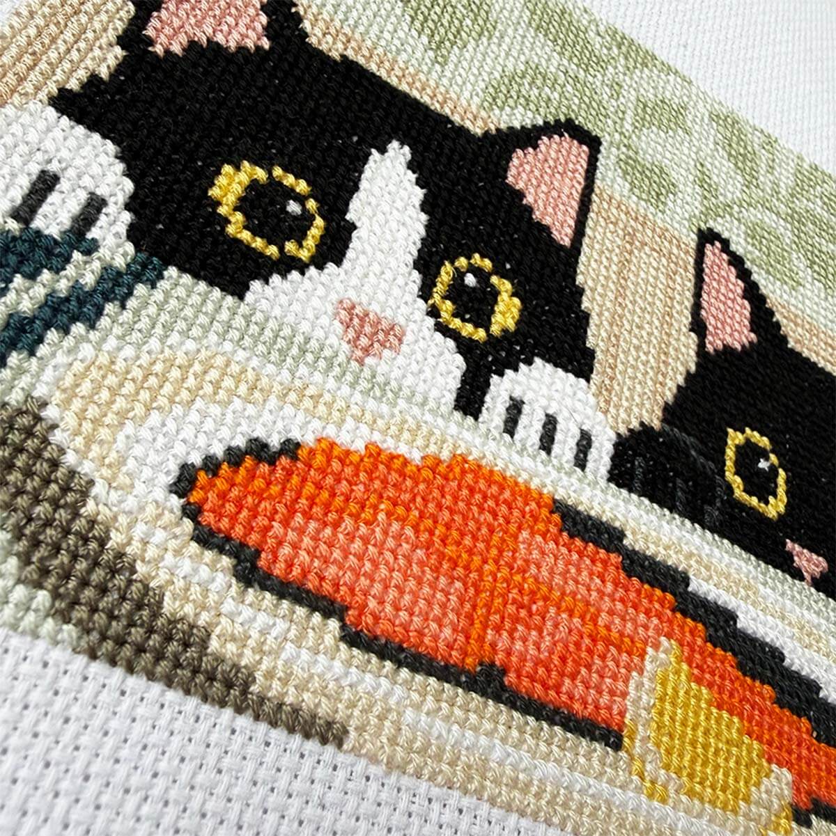 Close-up stitches of Dinner Inspectors cross stitch design showing thread texture and color details.